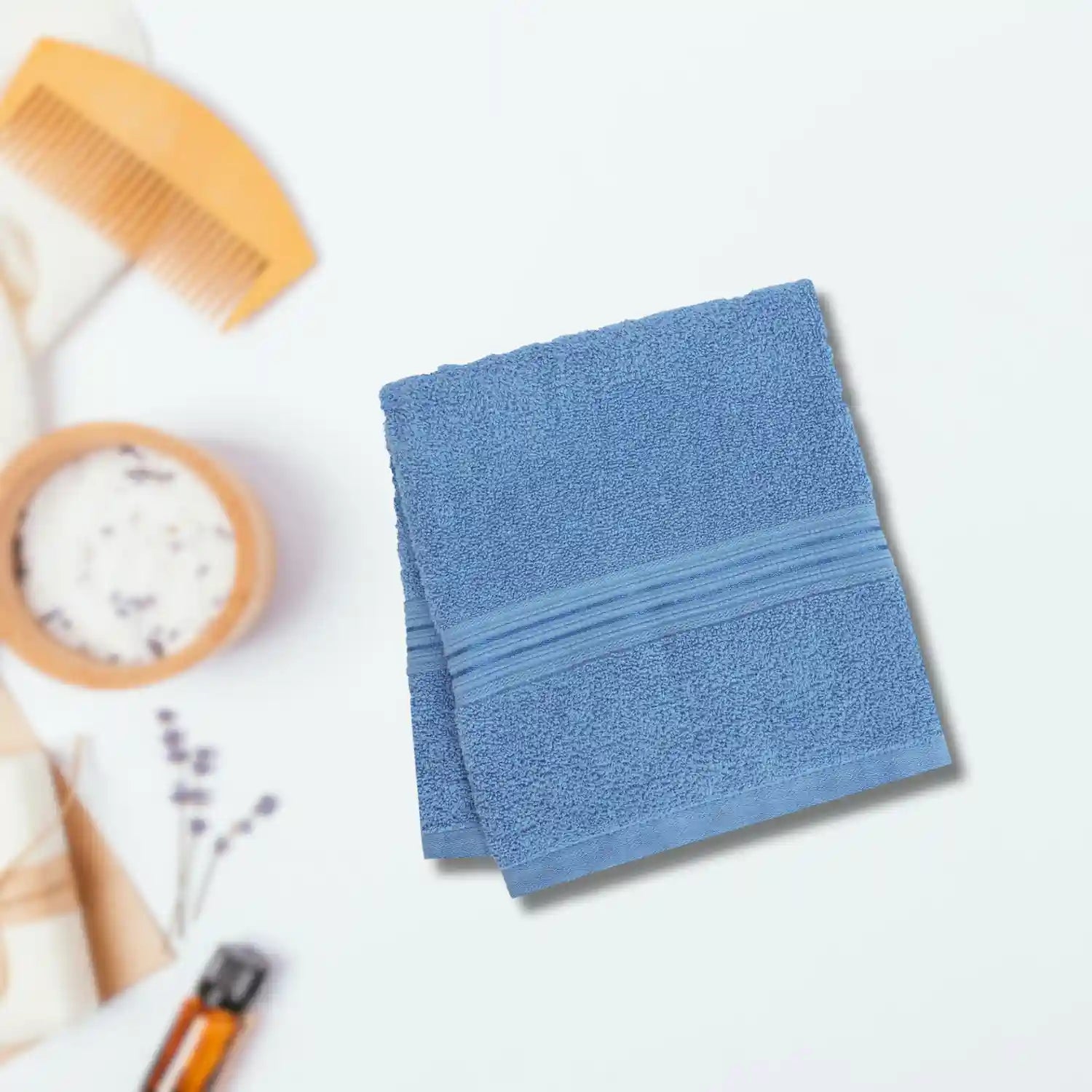 Luxury cotton bath towels stacked neatly in a hotel bathroom, providing guests with an upscale, soft experience.