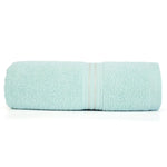 Soft cotton towel draped over a bathroom countertop, offering gentle care for all skin types.